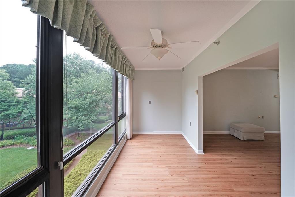 1800 Clairmont Lake, Unit A313 Decatur, GA 30033 - Photo 12 of 40 a view of an empty room with wooden floor and a window