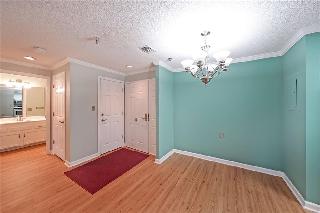 1800 Clairmont Lake, Unit A313 Decatur, GA 30033 - Photo 6 of 40 a view of a room with wooden floor and chandelier
