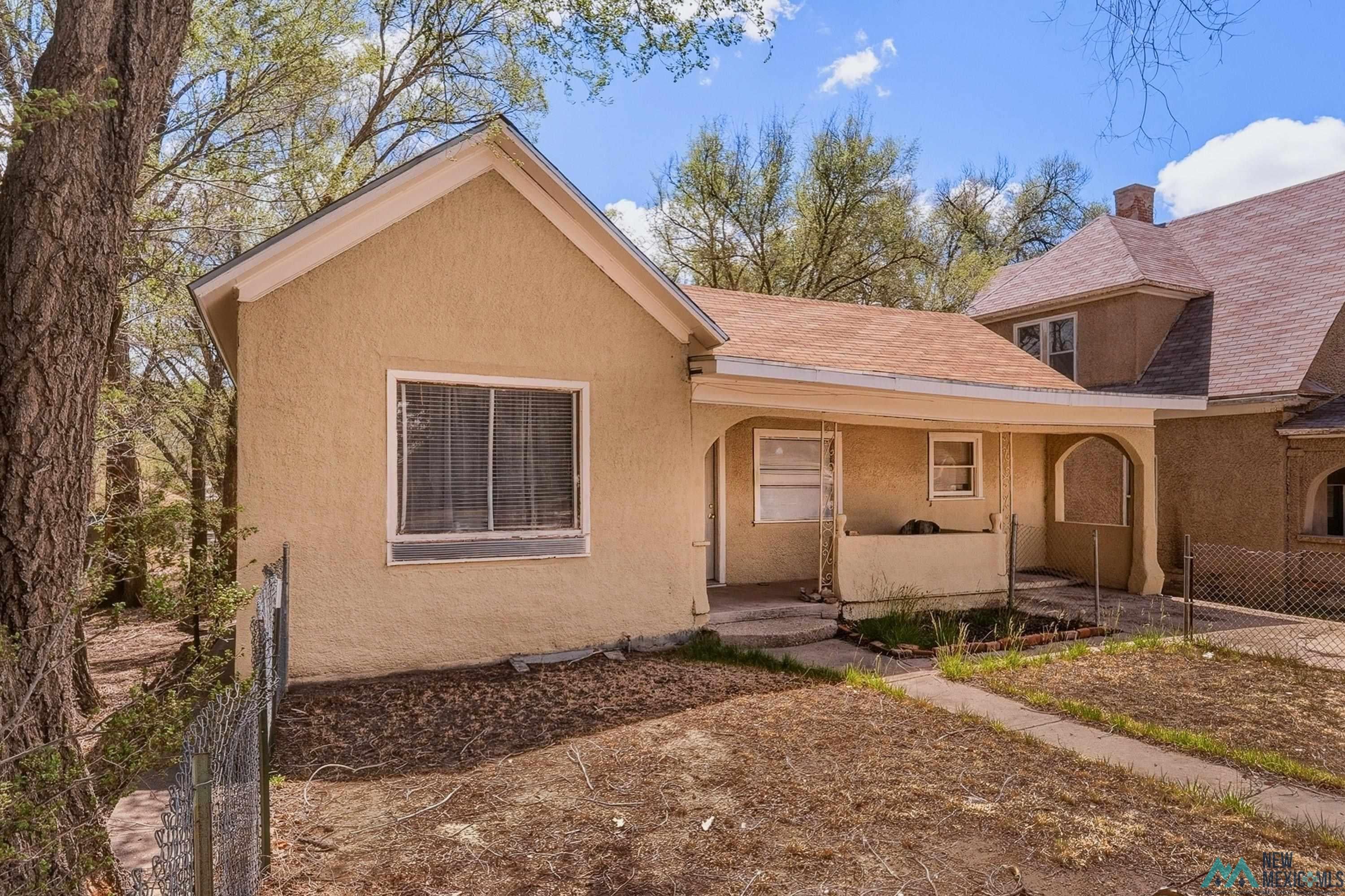 533 South 2nd Street Raton, NM 87740 - Photo 2 of 43 Stucco exterior featuring a covered porch, gabled roofline, and multiple windows