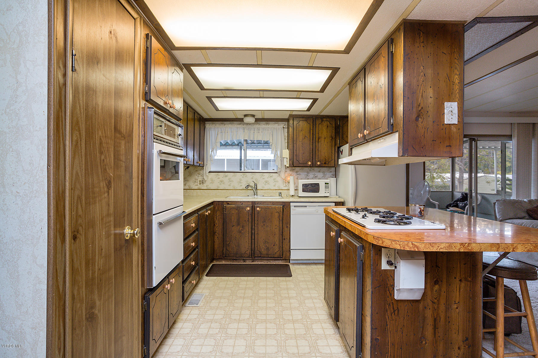6480 Katherine Road, Unit 3 Simi Valley, CA 93063 - Photo 11 of 28 a kitchen with stainless steel appliances granite countertop a sink a stove and a refrigerator