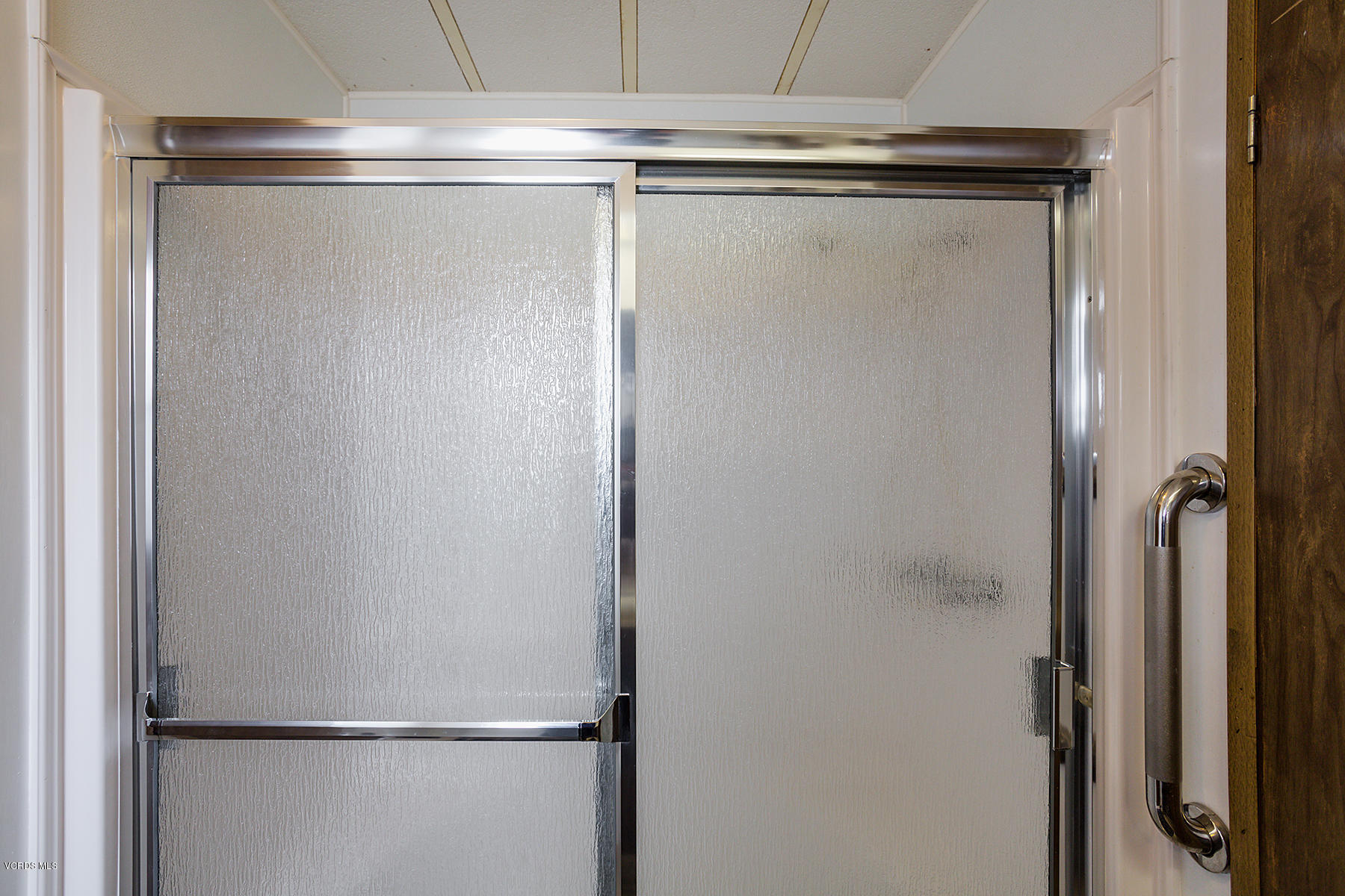 6480 Katherine Road, Unit 3 Simi Valley, CA 93063 - Photo 21 of 28 a bathroom with a glass shower door