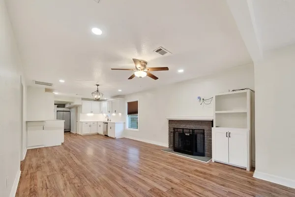 a view of a kitchen with a sink and a refrigerator