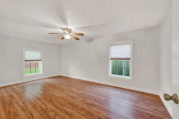 wooden floor in an empty room with a window