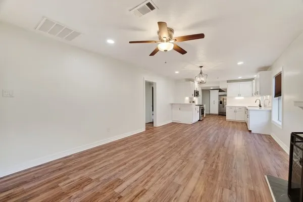 a view of a kitchen with a sink and wooden floor