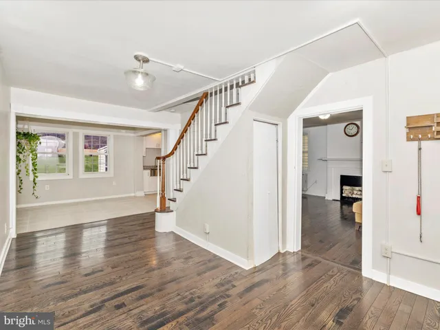a view of entryway and hall with wooden floor