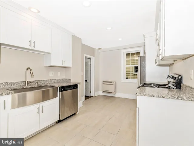 a kitchen with stainless steel appliances granite countertop a sink stove and cabinets