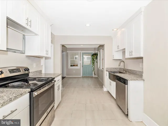 a kitchen with stainless steel appliances granite countertop a stove and a sink