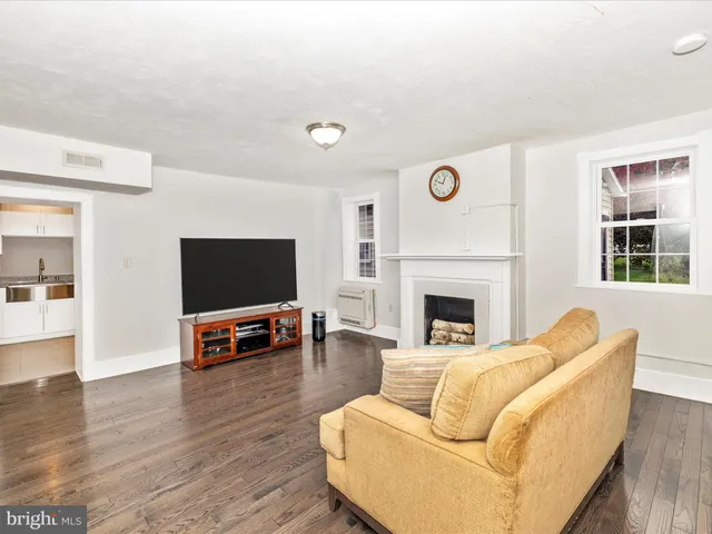 a living room with furniture flat screen tv and a fireplace