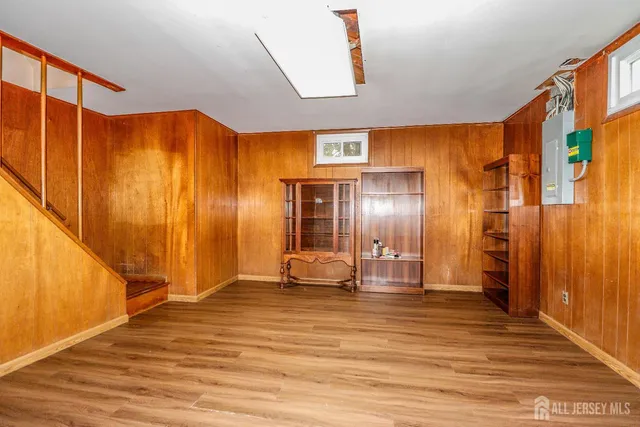 a view of a room with wooden floor and lounge chair
