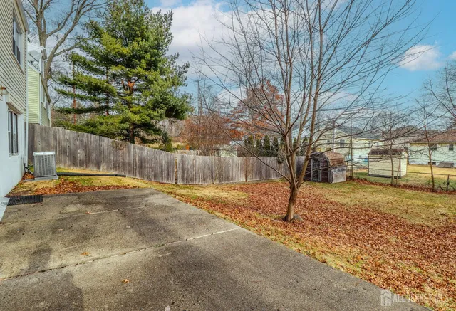 a view of a yard with snow on the road