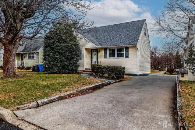 a view of a house with a yard and tree