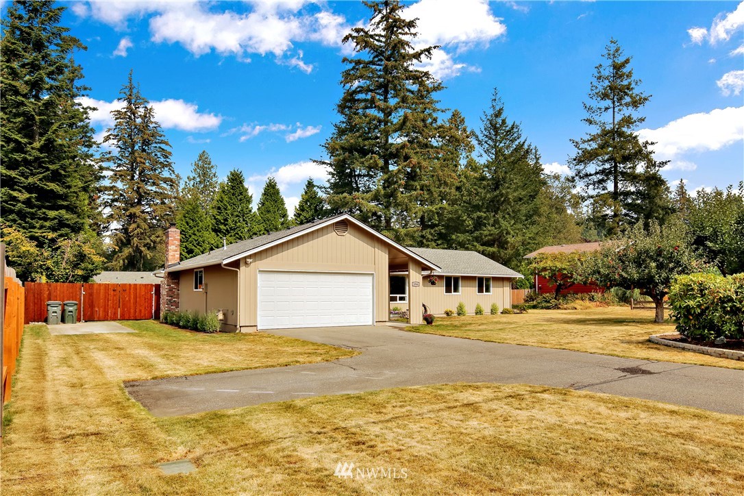 1064 West Laurel Road Ferndale, WA 98248 - Photo 2 of 39 a house that has a tree in front of it