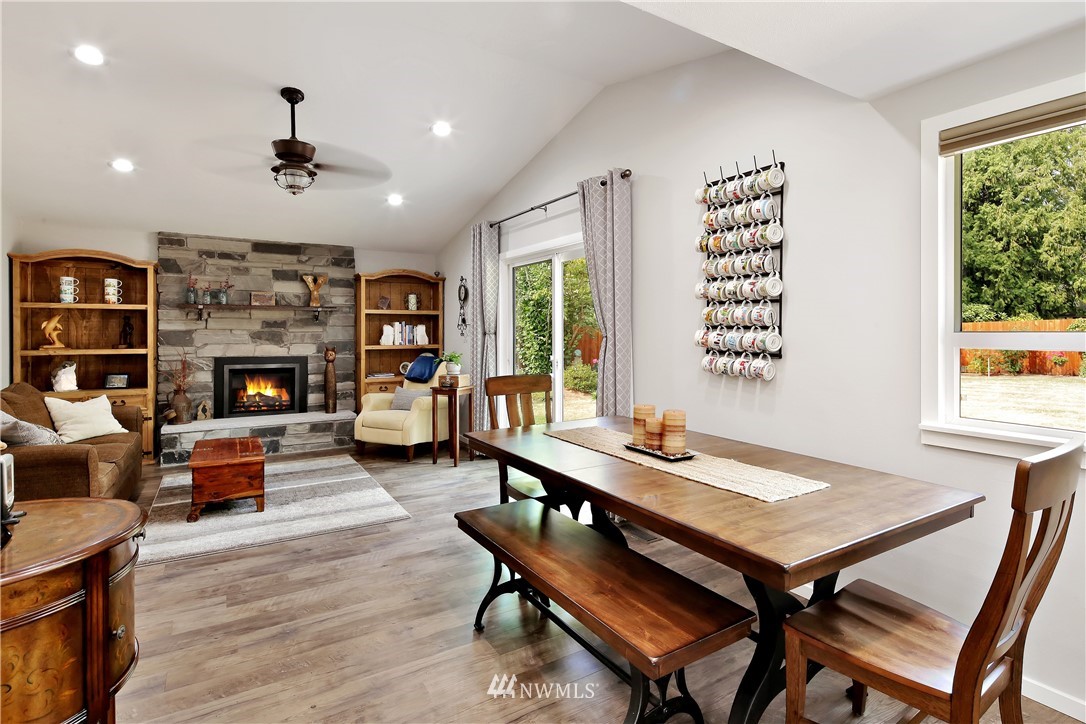 1064 West Laurel Road Ferndale, WA 98248 - Photo 13 of 39 a living room with fireplace furniture and a wooden floor