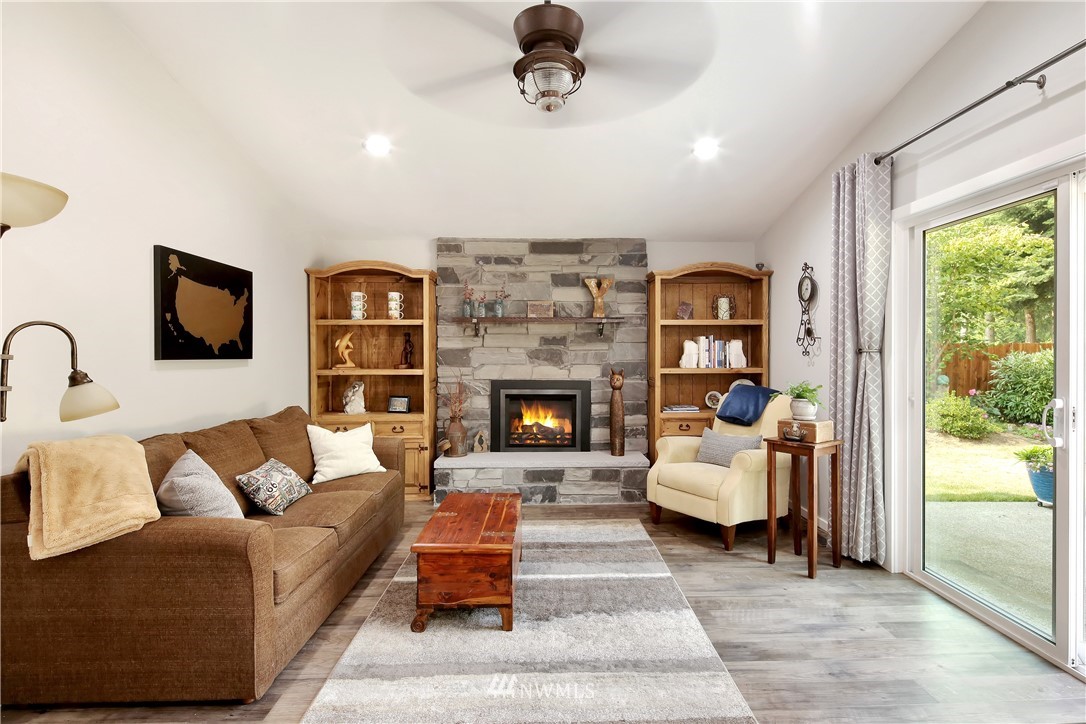 1064 West Laurel Road Ferndale, WA 98248 - Photo 14 of 39 a living room with furniture and a fireplace