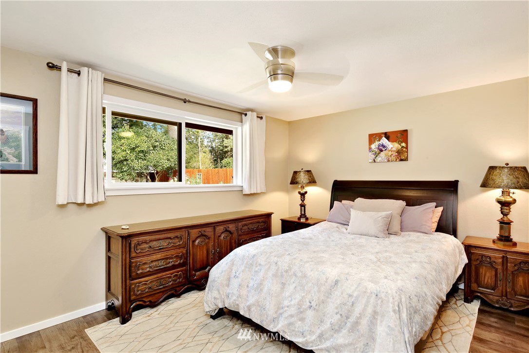 1064 West Laurel Road Ferndale, WA 98248 - Photo 18 of 39 a bedroom with a bed and a chandelier
