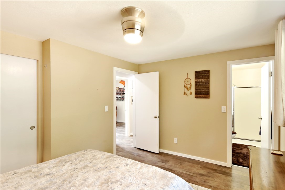 1064 West Laurel Road Ferndale, WA 98248 - Photo 19 of 39 a bedroom with a bed and a chandelier