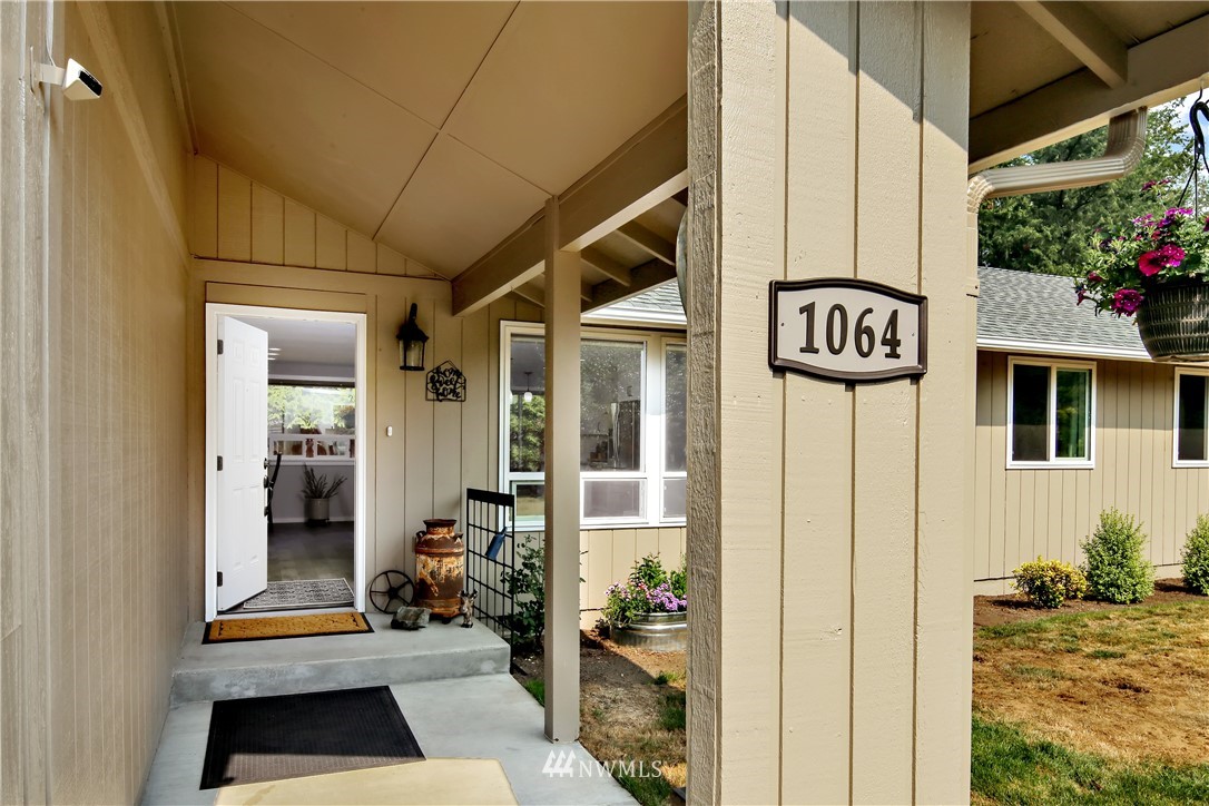 1064 West Laurel Road Ferndale, WA 98248 - Photo 3 of 39 a view of a door and a car parked front of a house