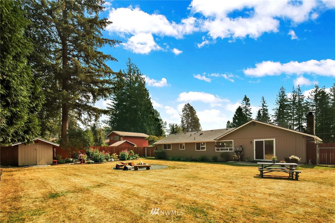 1064 West Laurel Road Ferndale, WA 98248 - Photo 27 of 39 a view of a house with a patio and a yard