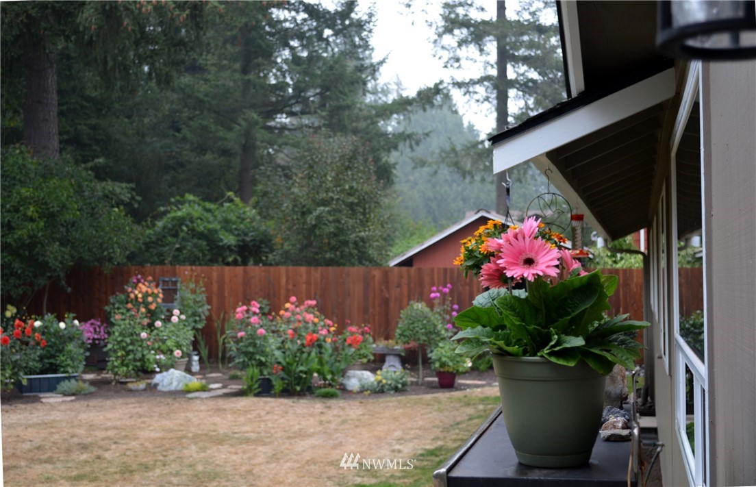 1064 West Laurel Road Ferndale, WA 98248 - Photo 31 of 39 a view of a potted flower in a yard