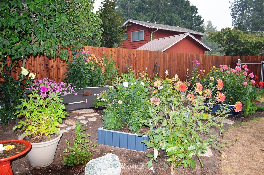 1064 West Laurel Road Ferndale, WA 98248 - Photo 35 of 39 a view of a house with a yard and garden