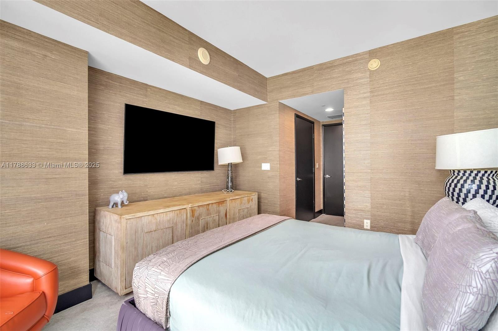 485 Brickell Avenue, Unit 2508 Miami, FL 33131 - Photo 12 of 20 a bedroom with a bed and a flat screen tv