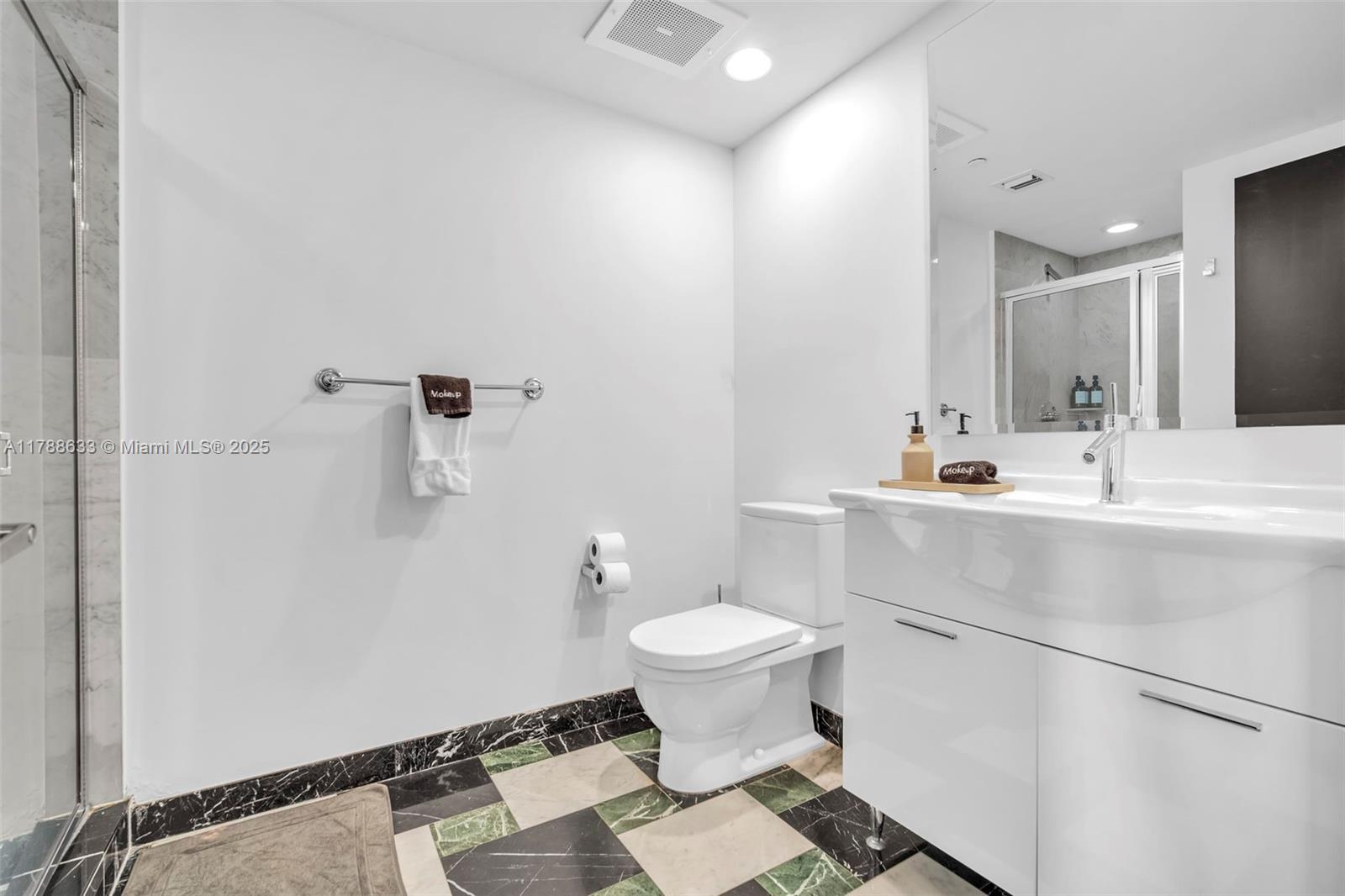 485 Brickell Avenue, Unit 2508 Miami, FL 33131 - Photo 14 of 20 a bathroom with a sink toilet and mirror