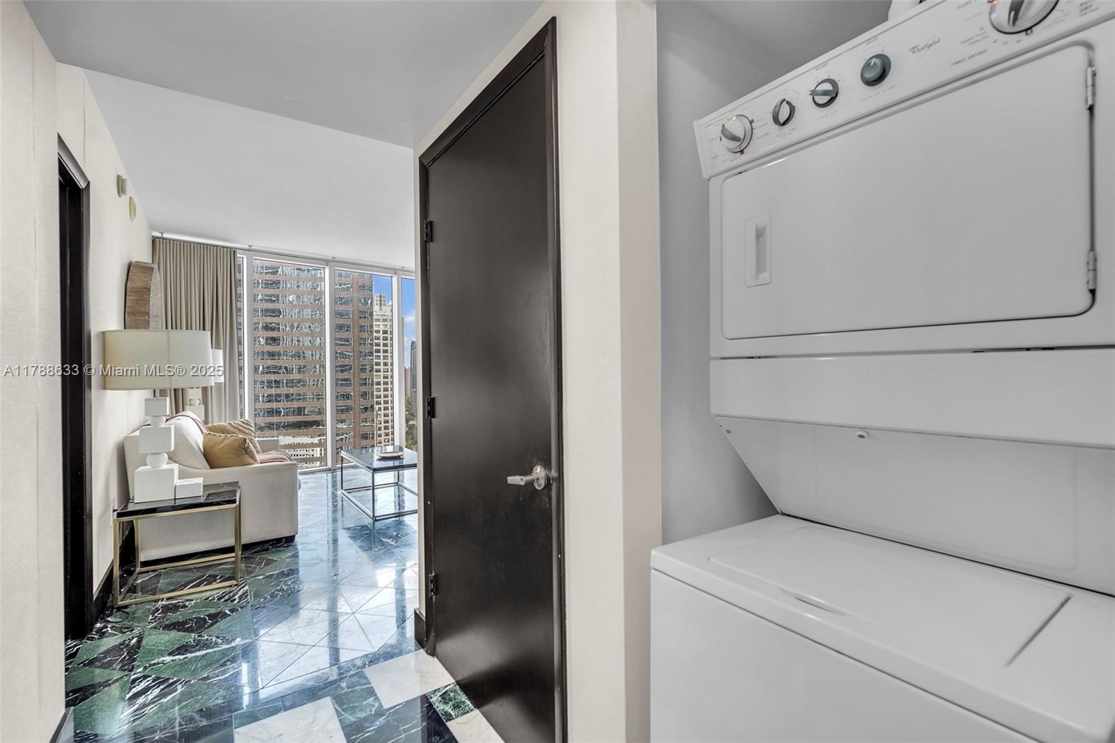 485 Brickell Avenue, Unit 2508 Miami, FL 33131 - Photo 16 of 20 a view of washer and dryer with bathroom in the background