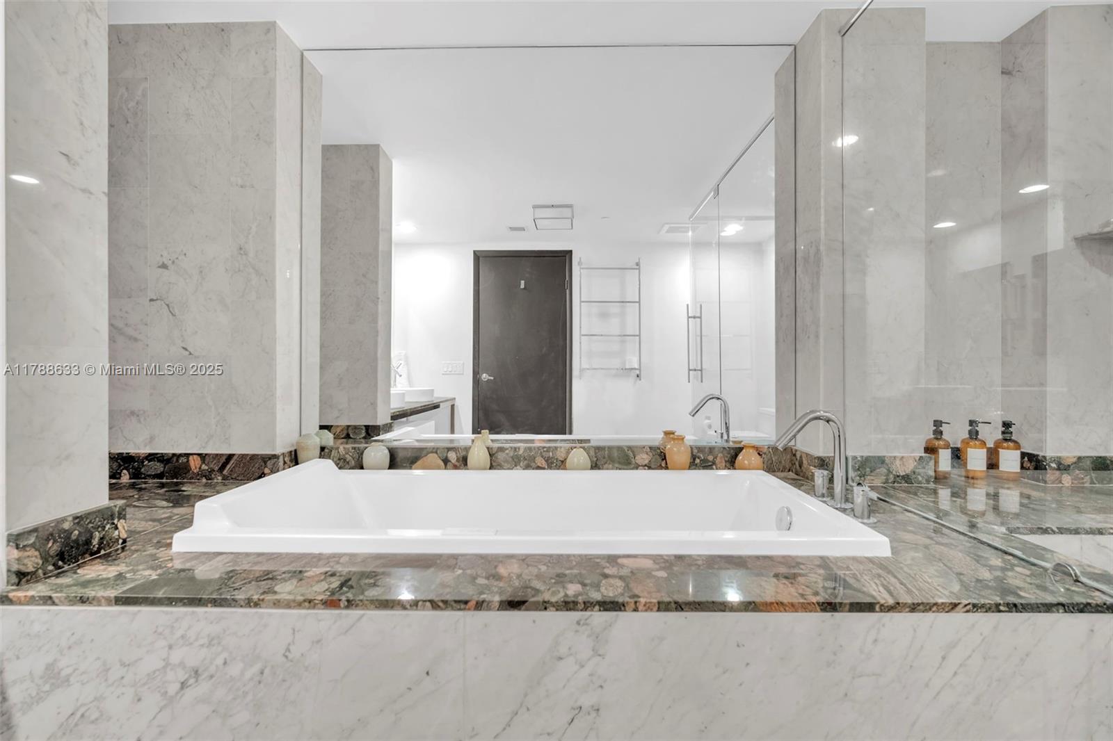 485 Brickell Avenue, Unit 2508 Miami, FL 33131 - Photo 17 of 20 a bathroom with a tub sink and mirror