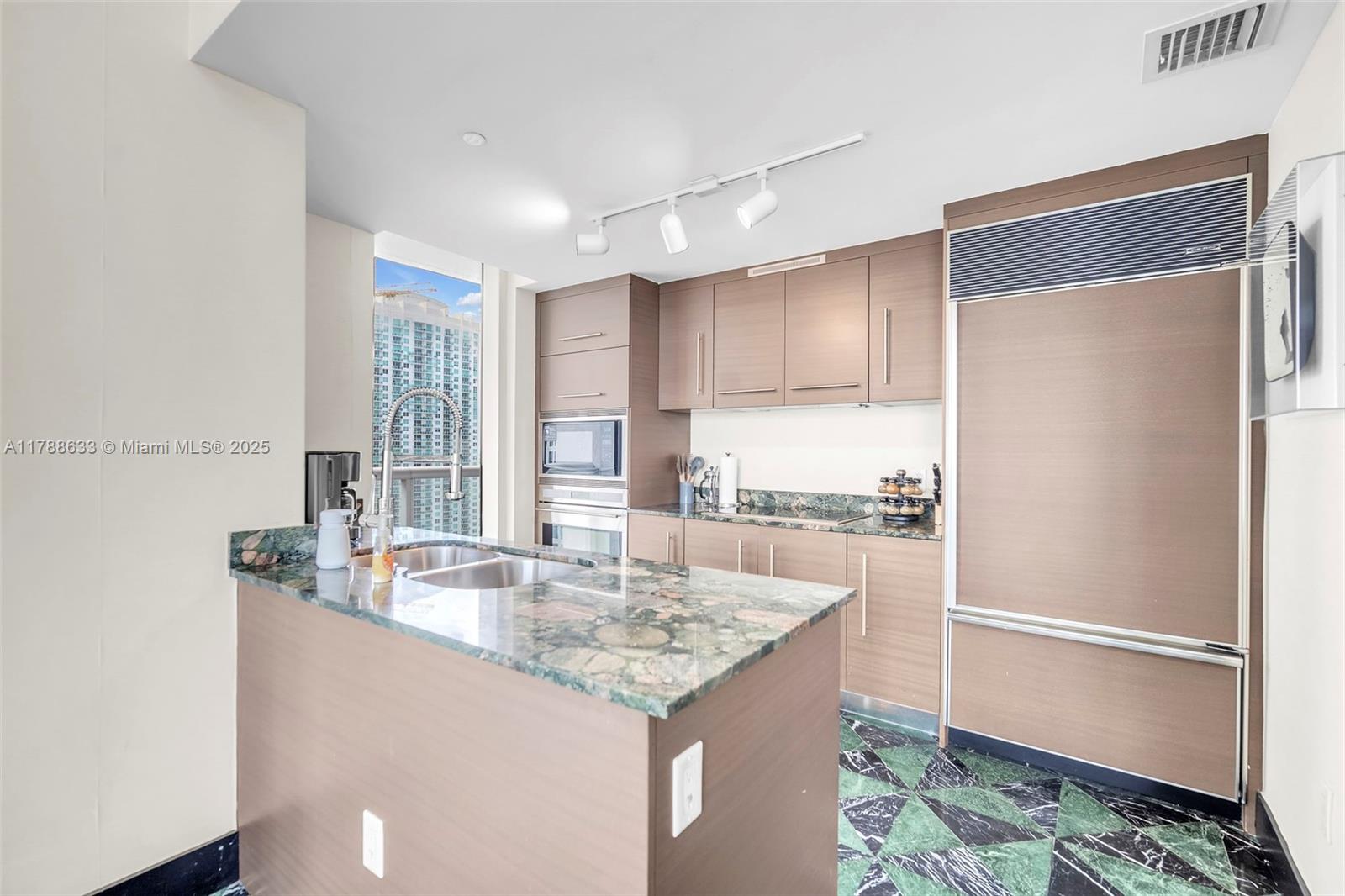 485 Brickell Avenue, Unit 2508 Miami, FL 33131 - Photo 6 of 20 a kitchen with stainless steel appliances granite countertop a refrigerator and a sink
