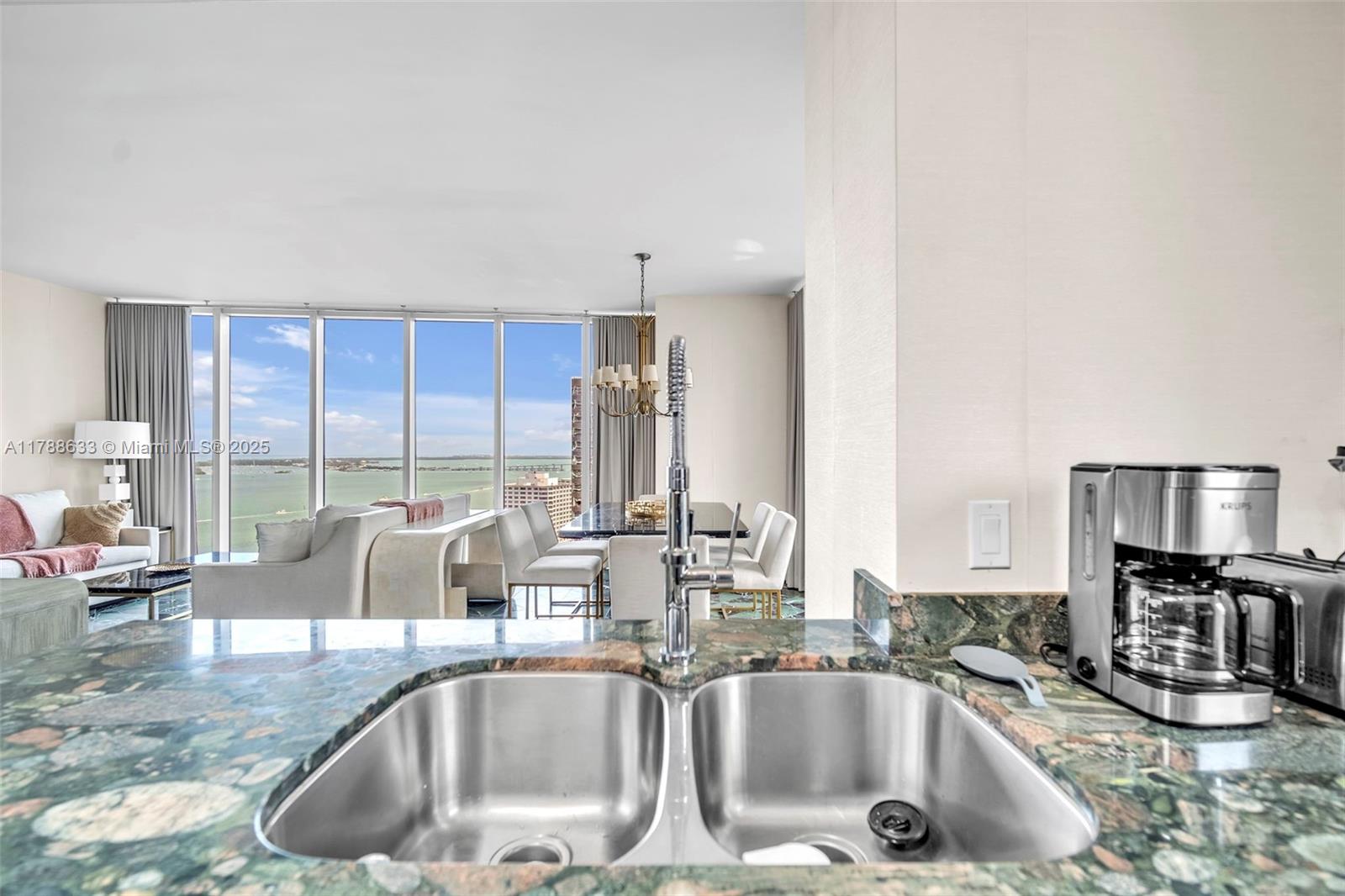 485 Brickell Avenue, Unit 2508 Miami, FL 33131 - Photo 7 of 20 a kitchen with a sink and a large window