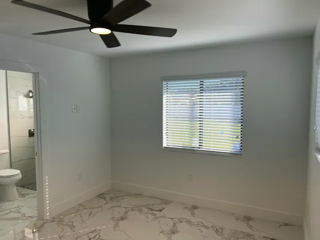 a bathroom with a sink toilet a mirror and shower