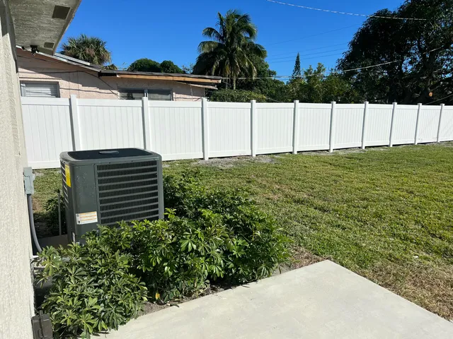 a view of a house with backyard and porch