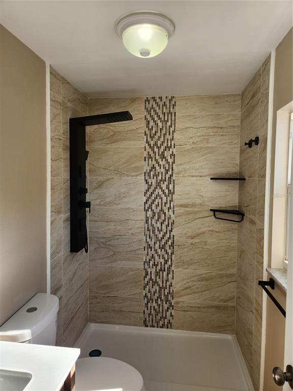 4462 Cynthia Lane Spring Hill, FL 34606 - Photo 11 of 22 a bathroom with a toilet and shower
