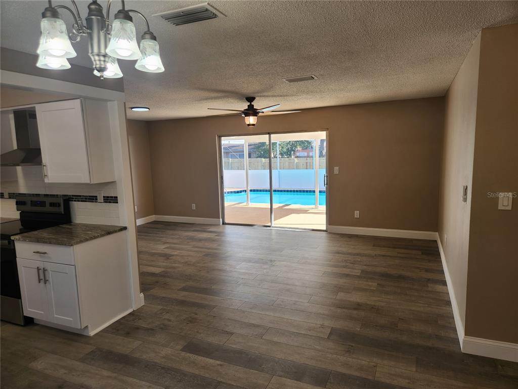 4462 Cynthia Lane Spring Hill, FL 34606 - Photo 16 of 22 wooden floor in an empty room with a window