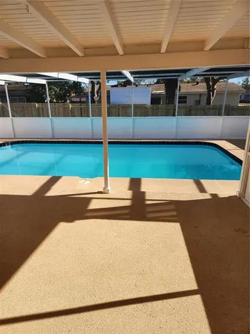a view of a swimming pool with a yard