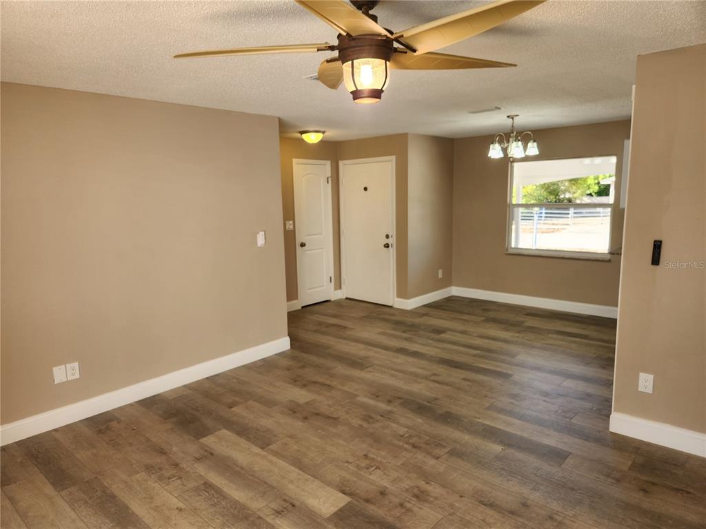 4462 Cynthia Lane Spring Hill, FL 34606 - Photo 6 of 22 an empty room with wooden floor windows and fan