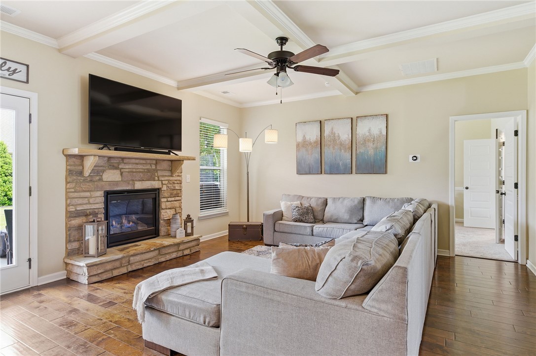 138 Buckland Drive Anderson, SC 29621 - Photo 11 of 49 This inviting living space features a cozy fireplace and rich hardwood flooring, perfect for comfortable gatherings.