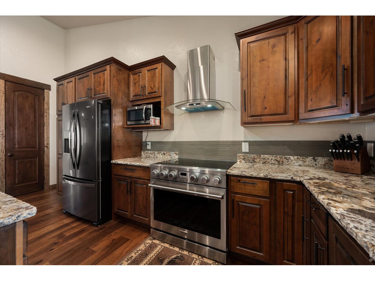 8626 County Road 22 Fort Lupton, CO 80621 - Photo 11 of 50 a kitchen with stainless steel appliances granite countertop a stove refrigerator and cabinets