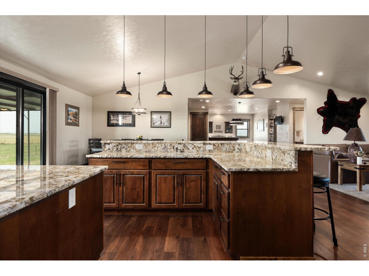 8626 County Road 22 Fort Lupton, CO 80621 - Photo 12 of 50 a kitchen with stainless steel appliances granite countertop a sink a stove and a wooden cabinets