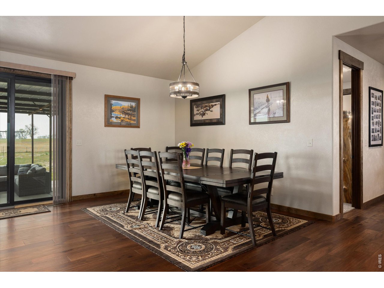 8626 County Road 22 Fort Lupton, CO 80621 - Photo 13 of 50 a dining room with furniture a chandelier and wooden floor