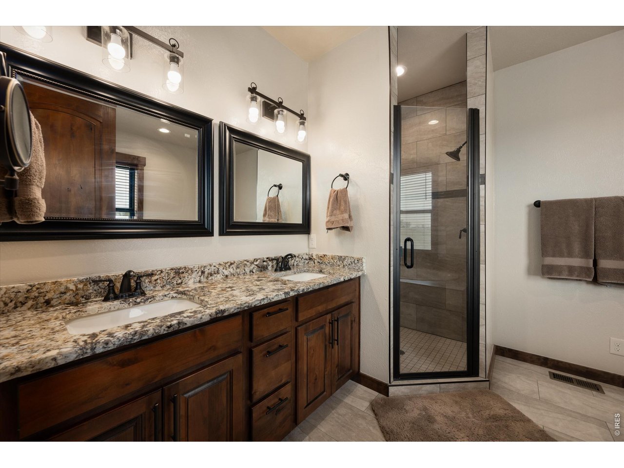 8626 County Road 22 Fort Lupton, CO 80621 - Photo 20 of 50 a bathroom with a sink a mirror and a shower