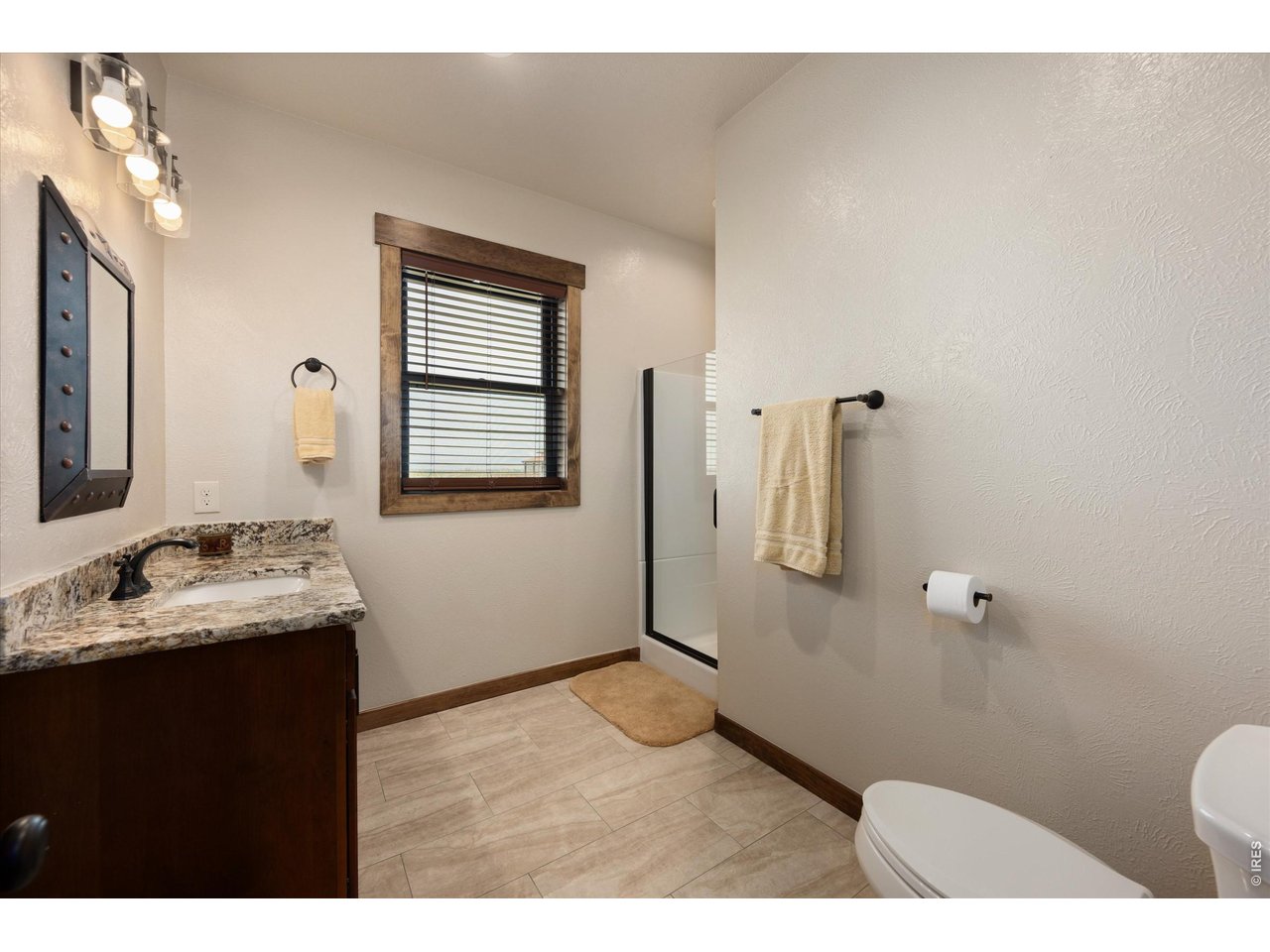 8626 County Road 22 Fort Lupton, CO 80621 - Photo 24 of 50 a bathroom with a sink toilet and mirror