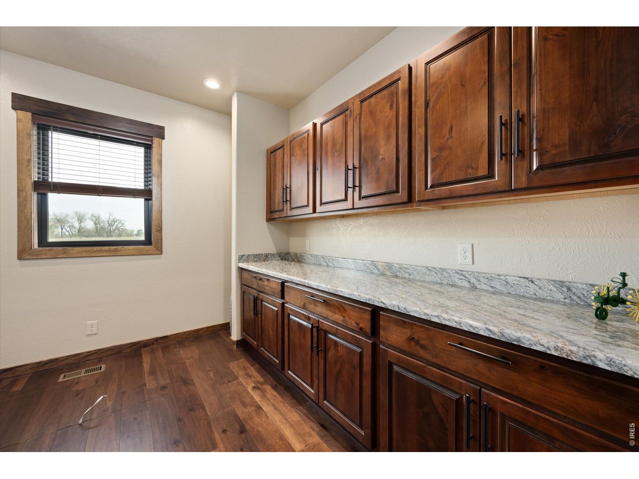 8626 County Road 22 Fort Lupton, CO 80621 - Photo 29 of 50 a kitchen with granite countertop wooden cabinets a sink and dishwasher