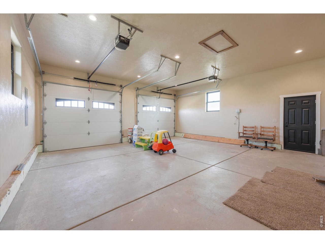 8626 County Road 22 Fort Lupton, CO 80621 - Photo 31 of 50 a view of a garage with furniture and a ceiling fan