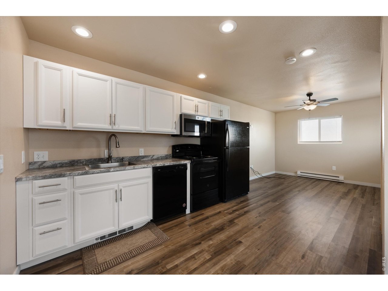 8626 County Road 22 Fort Lupton, CO 80621 - Photo 36 of 50 a kitchen with granite countertop stainless steel appliances and wooden cabinets