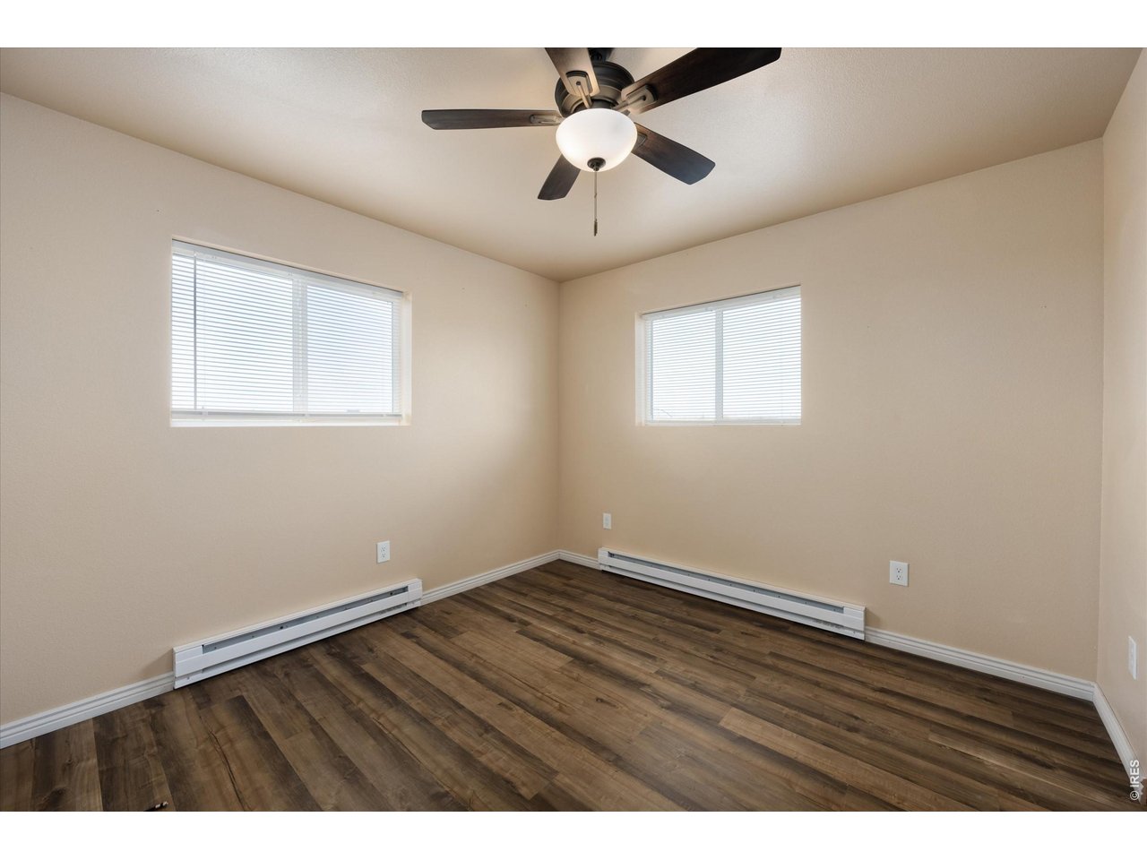 8626 County Road 22 Fort Lupton, CO 80621 - Photo 38 of 50 an empty room with wooden floor and windows