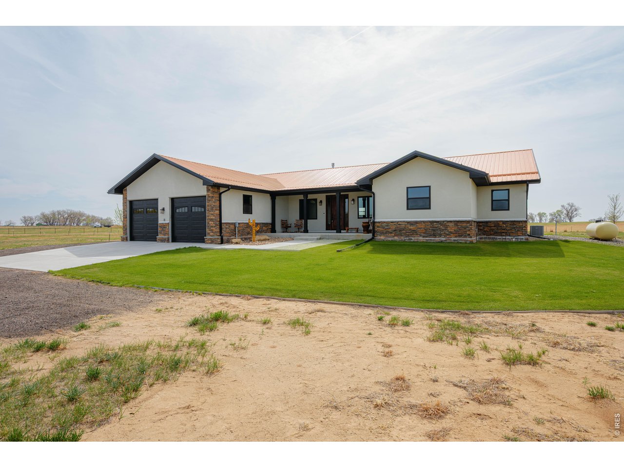8626 County Road 22 Fort Lupton, CO 80621 - Photo 4 of 50 a view of a house with a yard and large trees