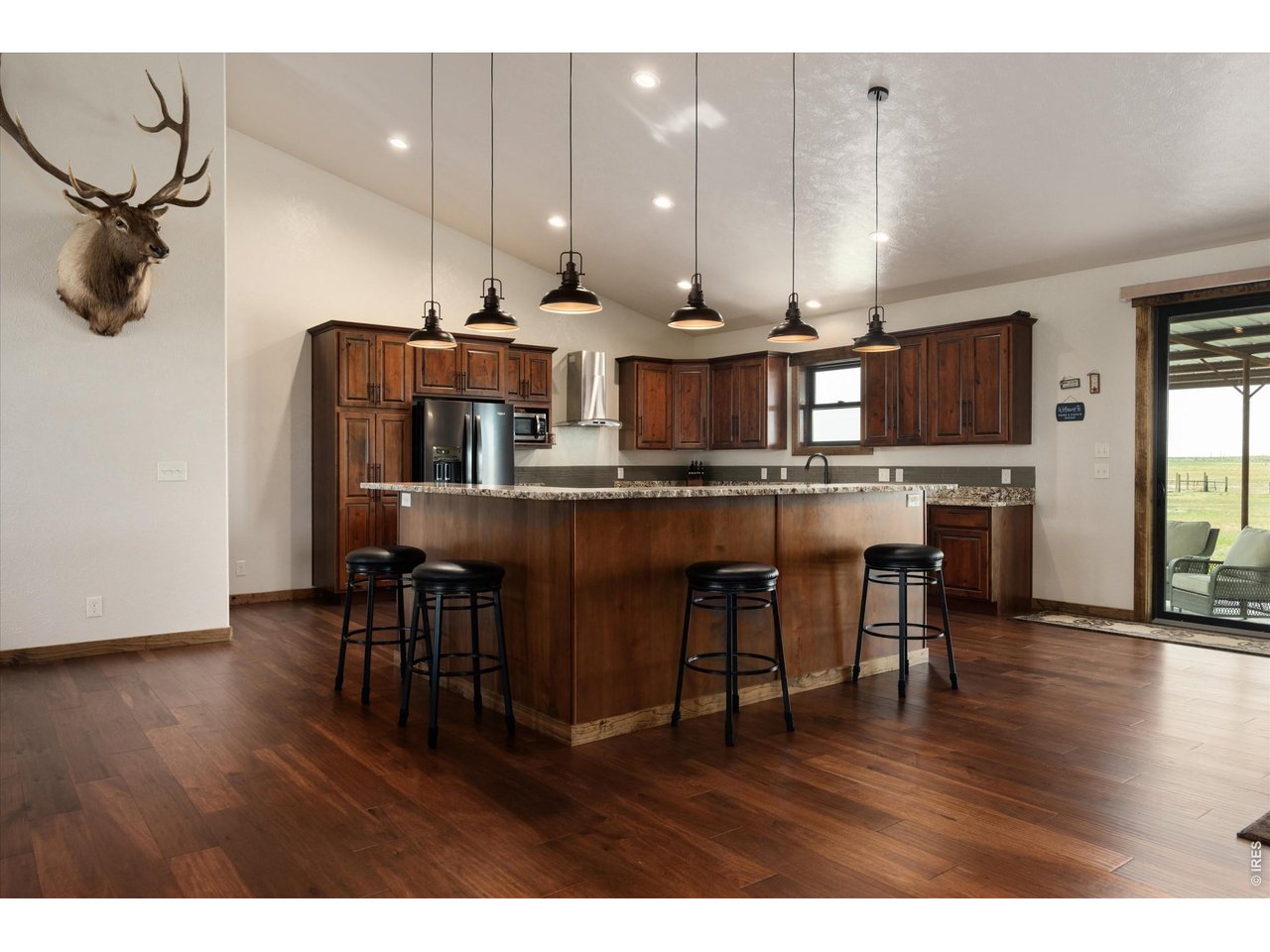 8626 County Road 22 Fort Lupton, CO 80621 - Photo 8 of 50 a view of a dining room with furniture and wooden floor