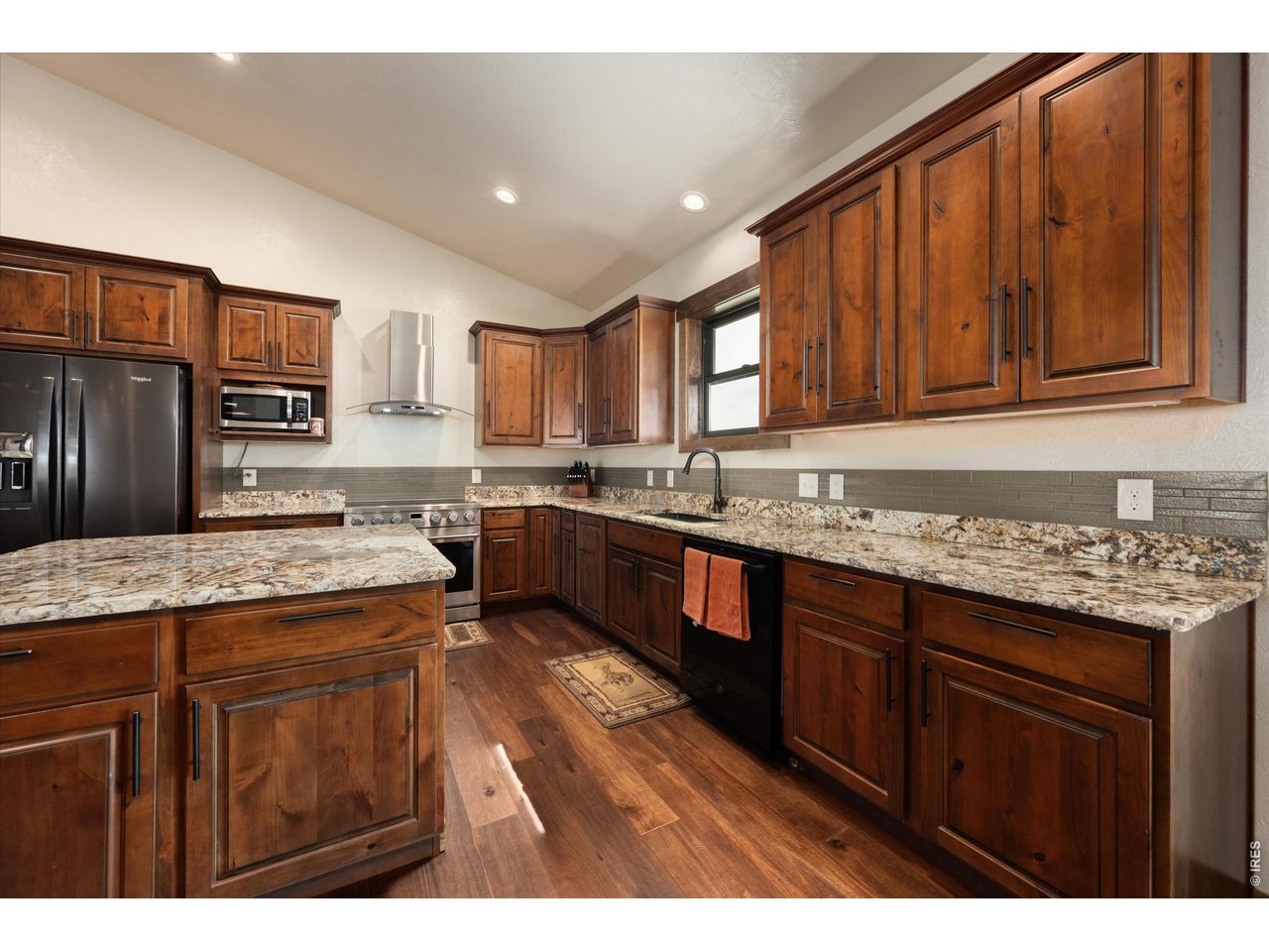 8626 County Road 22 Fort Lupton, CO 80621 - Photo 9 of 50 a kitchen with kitchen island granite countertop wooden cabinets a sink and dishwasher