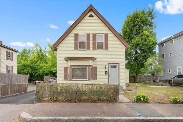 a view of a yard in front view of a house
